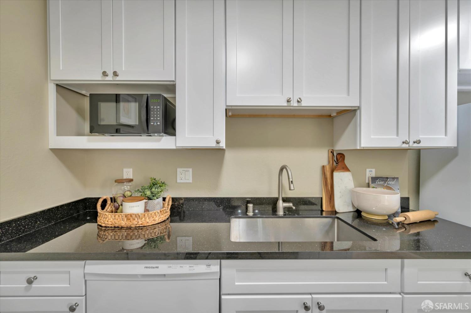 1585 10th Avenue, Unit 3 San Francisco, CA 94122 - Photo 12 of 32 a kitchen with granite countertop white cabinets and white appliances