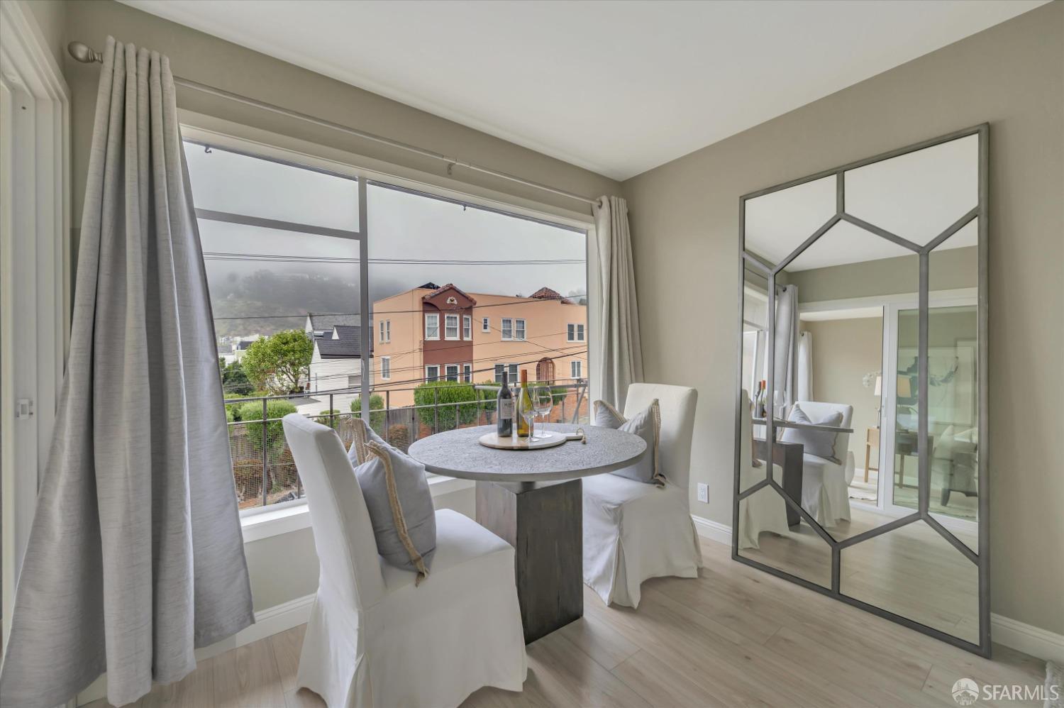 1585 10th Avenue, Unit 3 San Francisco, CA 94122 - Photo 14 of 32 a dining room with furniture a livingroom view and wooden floor