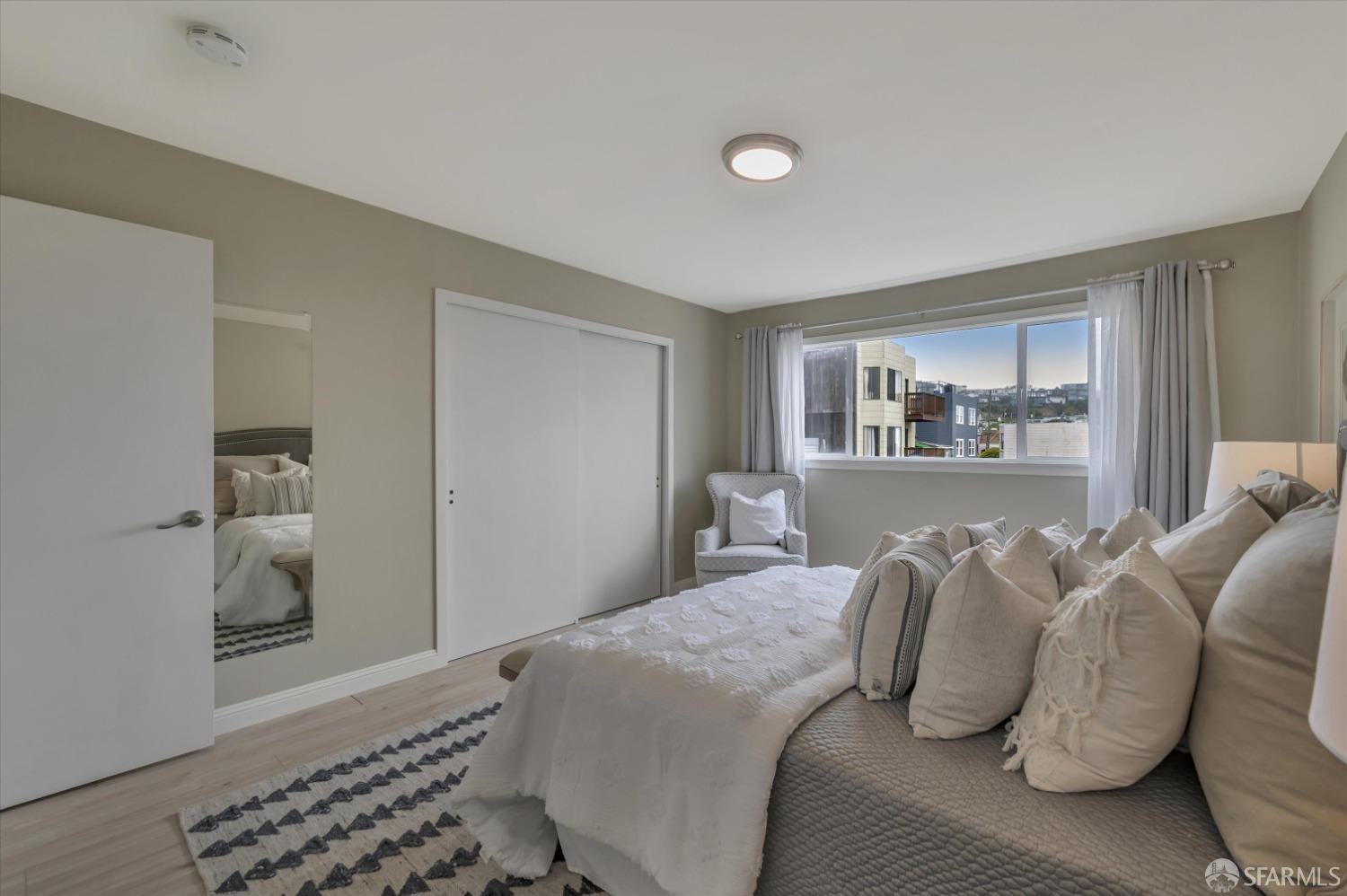 1585 10th Avenue, Unit 3 San Francisco, CA 94122 - Photo 20 of 32 a bedroom with a large bed and a window