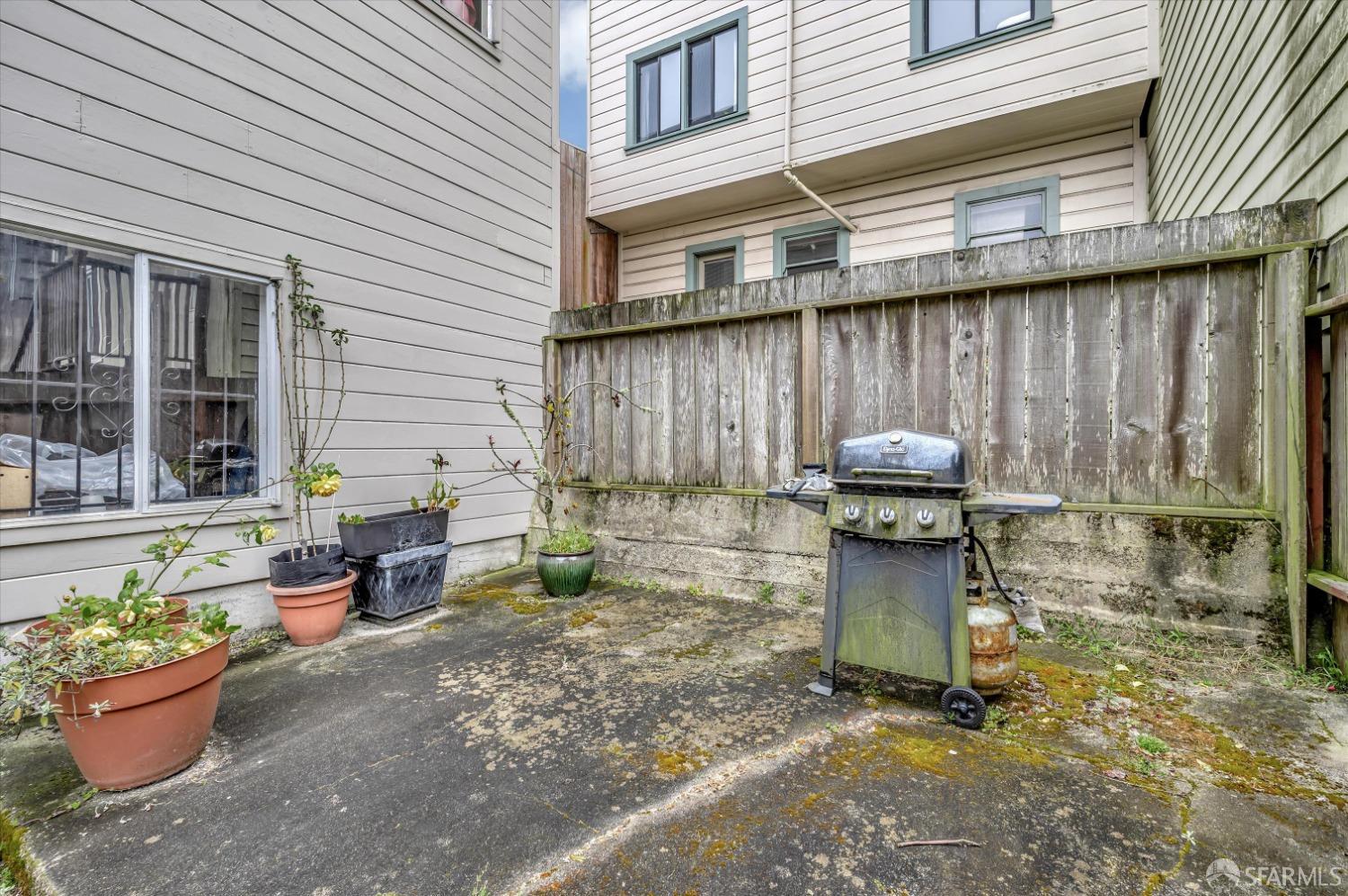 1585 10th Avenue, Unit 3 San Francisco, CA 94122 - Photo 31 of 32 a view of a patio with table and chairs and potted plants