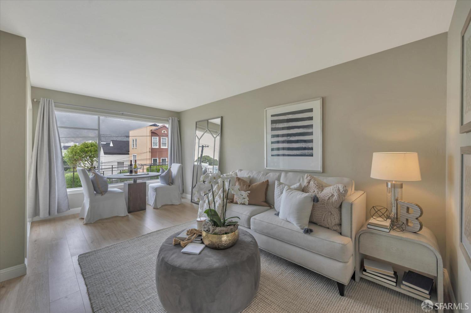 1585 10th Avenue, Unit 3 San Francisco, CA 94122 - Photo 7 of 32 a living room with furniture and a wooden floor