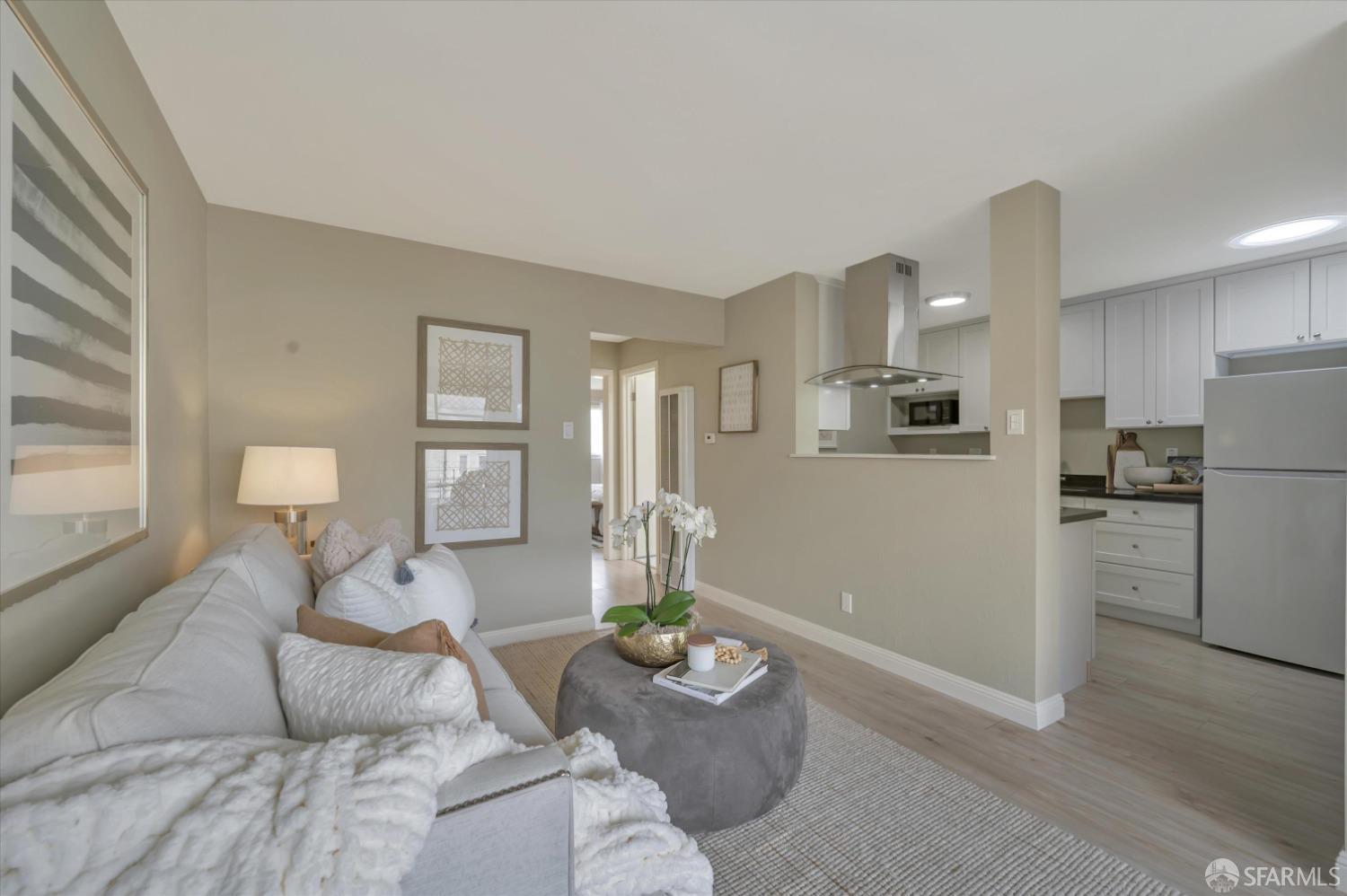 1585 10th Avenue, Unit 3 San Francisco, CA 94122 - Photo 9 of 32 a living room with furniture and wooden floor