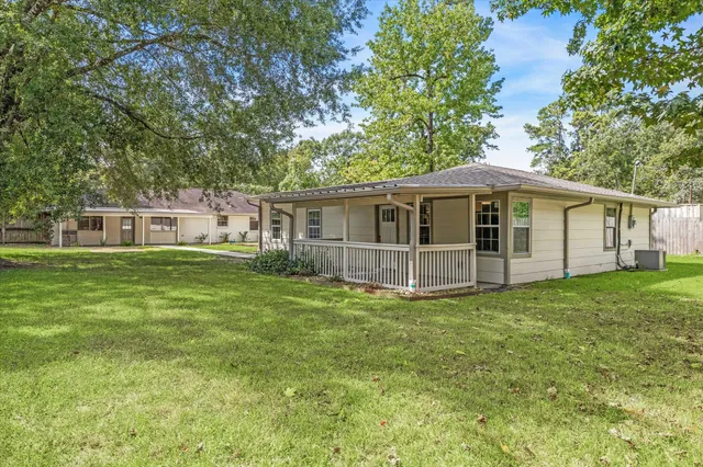 a view of a house with a backyard