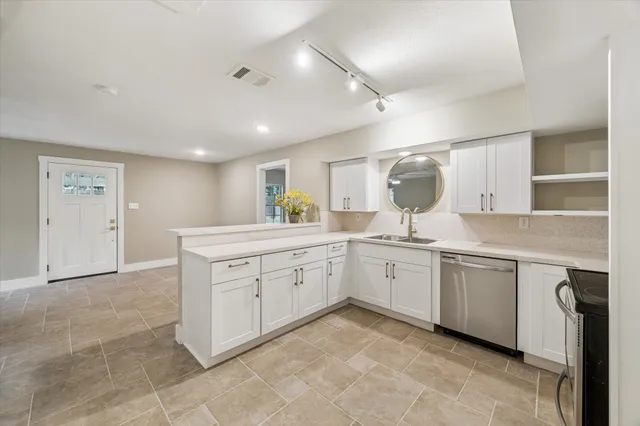 a kitchen with a sink window and cabinets