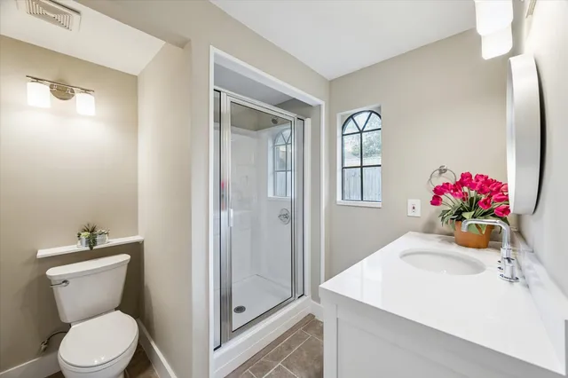 a bathroom with a sink toilet and shower