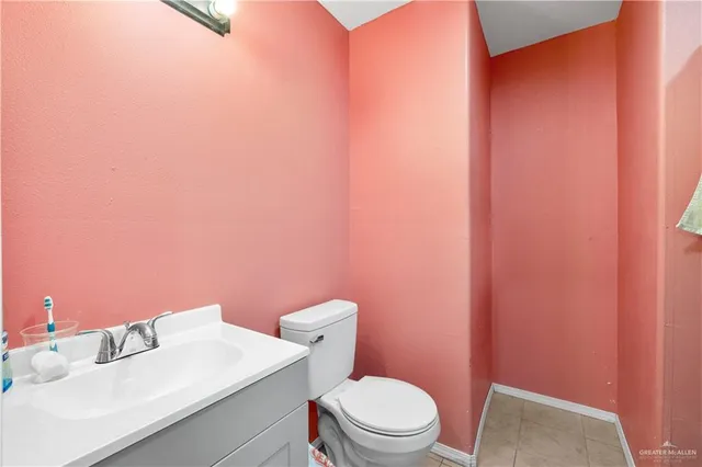 a white toilet sitting next to a bathroom sink