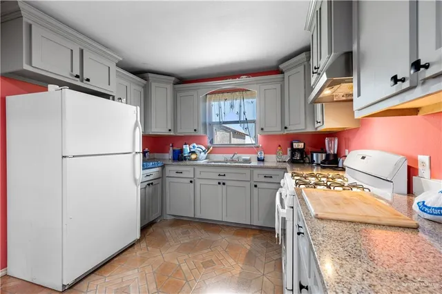 a kitchen with a refrigerator a stove a sink and a microwave