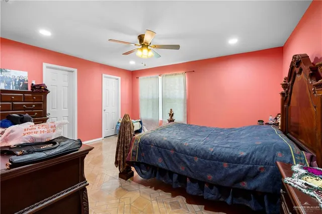 a bed room with a bed and a ceiling fan