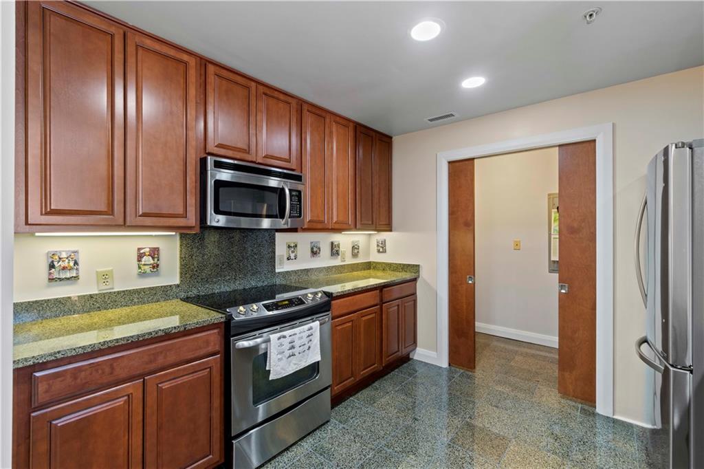 306 Fourth Avenue, Unit 1203 Pittsburgh, PA 15222 - Photo 15 of 40 a kitchen with stainless steel appliances granite countertop a stove a sink and a refrigerator