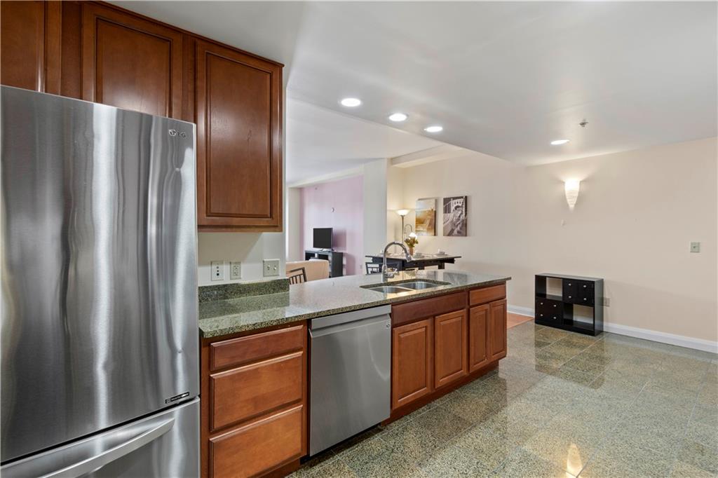 306 Fourth Avenue, Unit 1203 Pittsburgh, PA 15222 - Photo 17 of 40 a kitchen with stainless steel appliances granite countertop a refrigerator and a stove