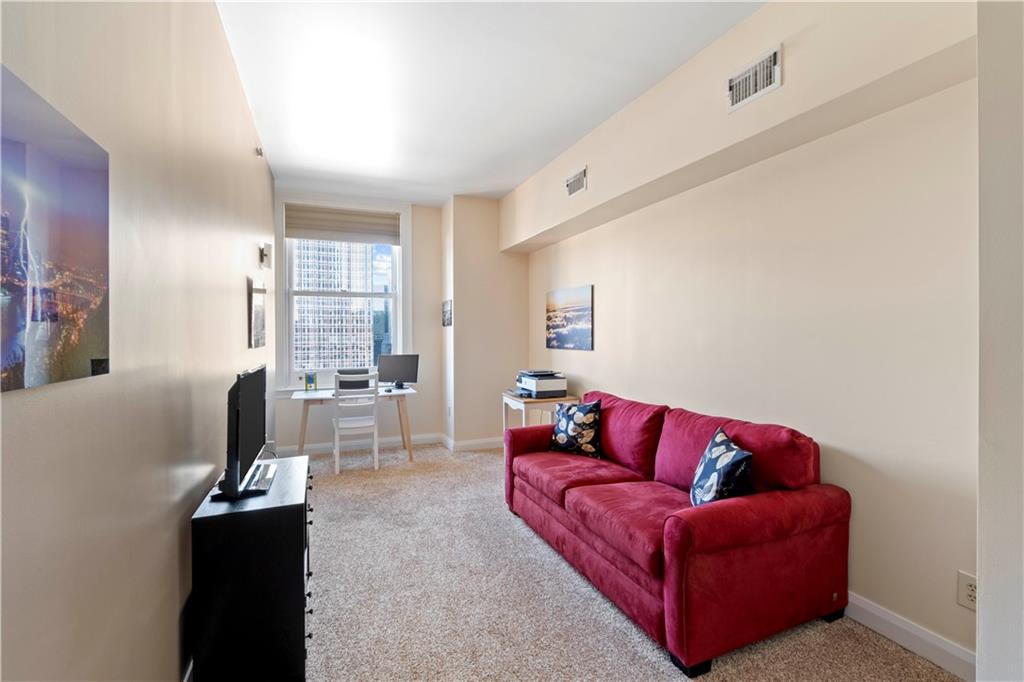 306 Fourth Avenue, Unit 1203 Pittsburgh, PA 15222 - Photo 29 of 40 a living room with furniture and a flat screen tv