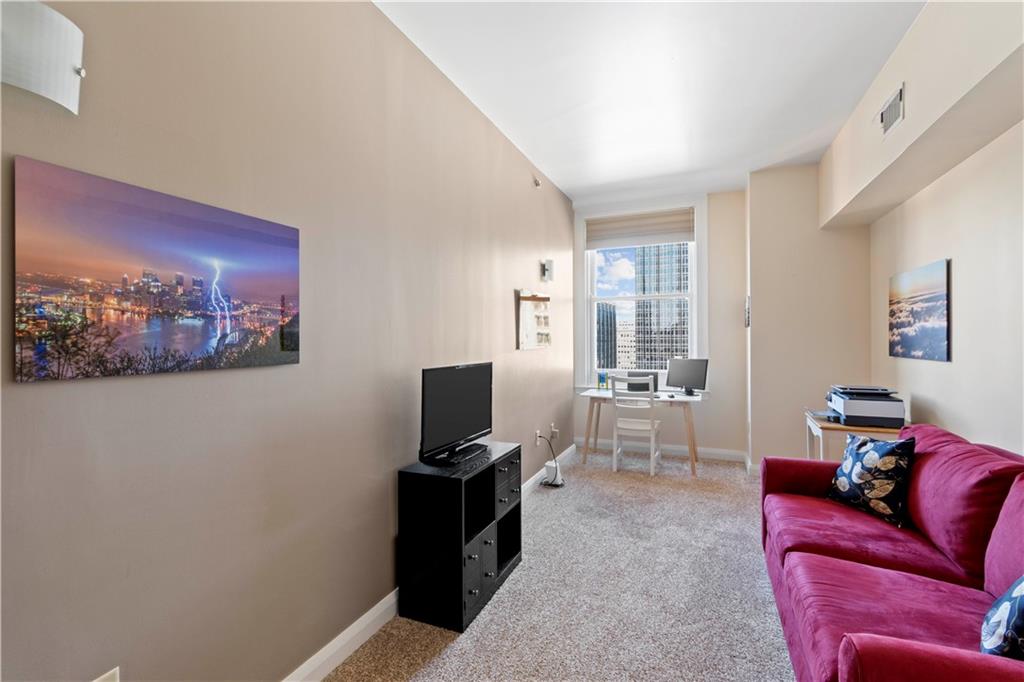 306 Fourth Avenue, Unit 1203 Pittsburgh, PA 15222 - Photo 30 of 40 a living room with furniture a rug and a window