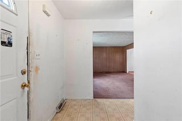 a hallway with furniture and a wooden floor