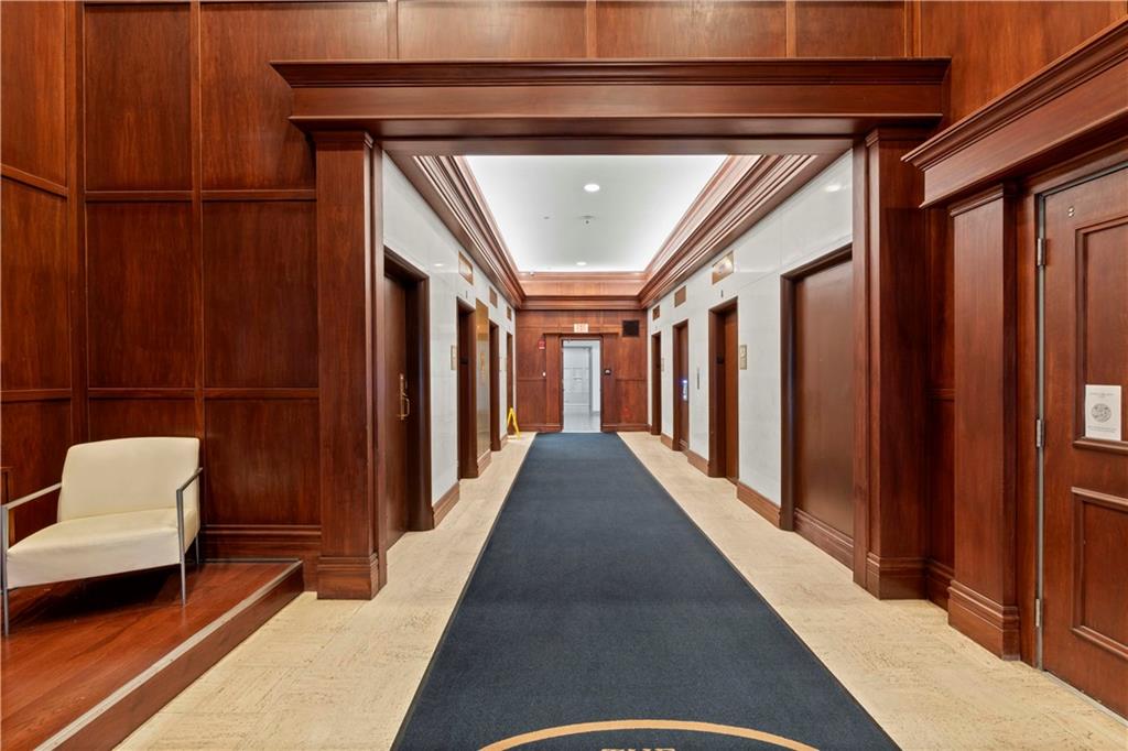 306 Fourth Avenue, Unit 1203 Pittsburgh, PA 15222 - Photo 33 of 40 a hallway with furniture and a wooden floor