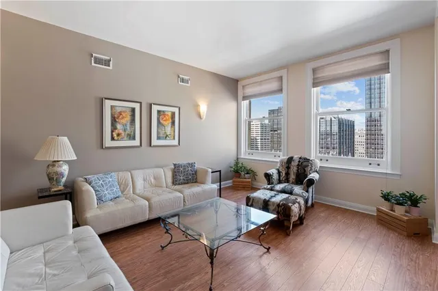 a living room with furniture and wooden floor