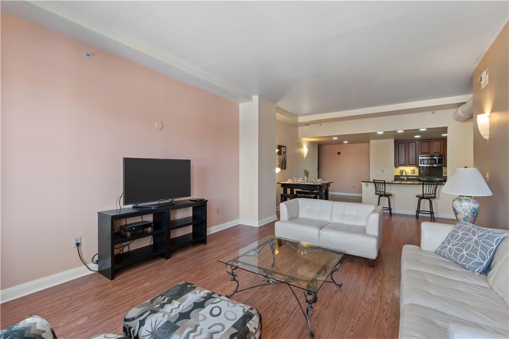 306 Fourth Avenue, Unit 1203 Pittsburgh, PA 15222 - Photo 9 of 40 a living room with furniture and a flat screen tv
