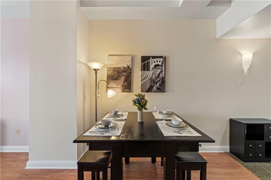 306 Fourth Avenue, Unit 1203 Pittsburgh, PA 15222 - Photo 10 of 40 a view of a dining room with furniture and wooden floor