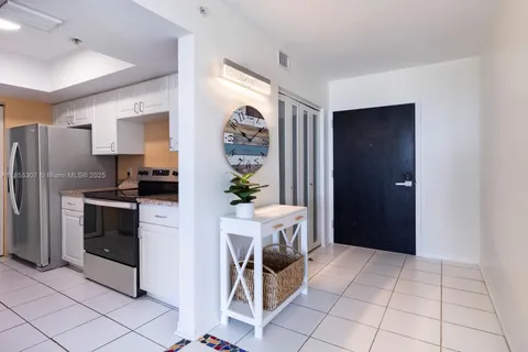 a kitchen with granite countertop a sink stove and cabinets