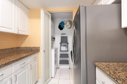 a bathroom with a granite countertop sink toilet and a mirror