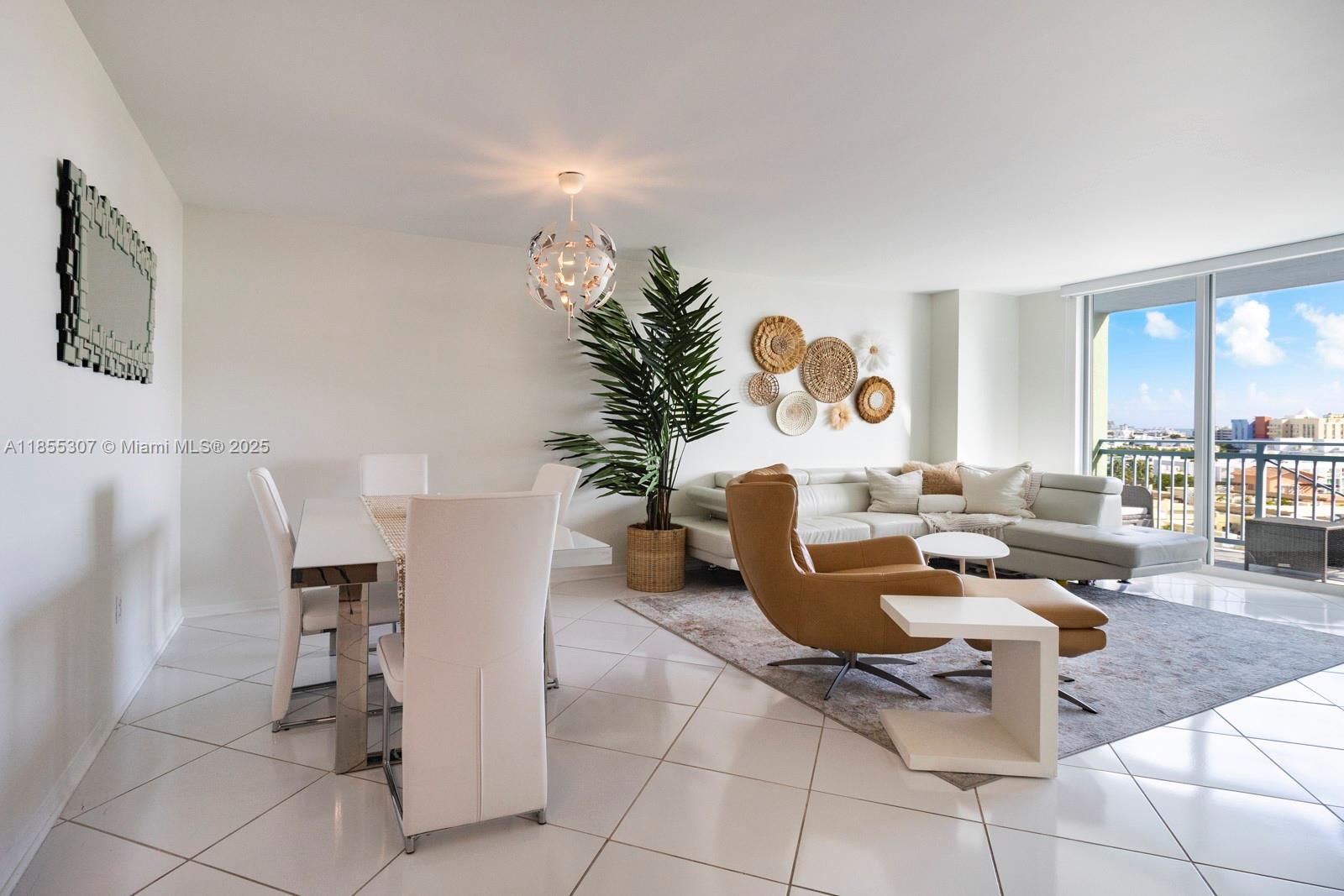 90 Alton Road, Unit 1005 Miami Beach, FL 33139 - Photo 3 of 22 a living room with furniture and a potted plant