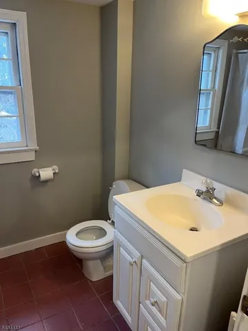 a bathroom with a sink toilet and mirror