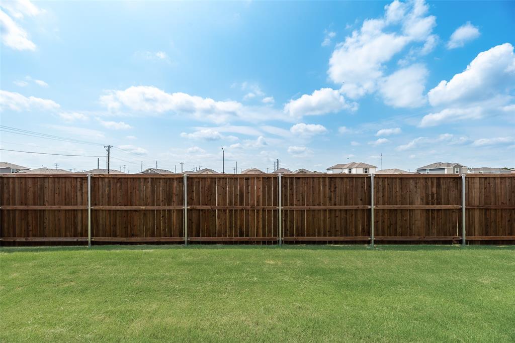 110 Hesed Street Greenville, TX 75402 - Photo 25 of 33 a view of a backyard with wooden fence