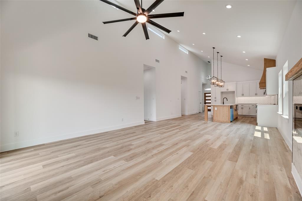 110 Hesed Street Greenville, TX 75402 - Photo 10 of 33 a view of empty room with kitchen appliances and wooden floor