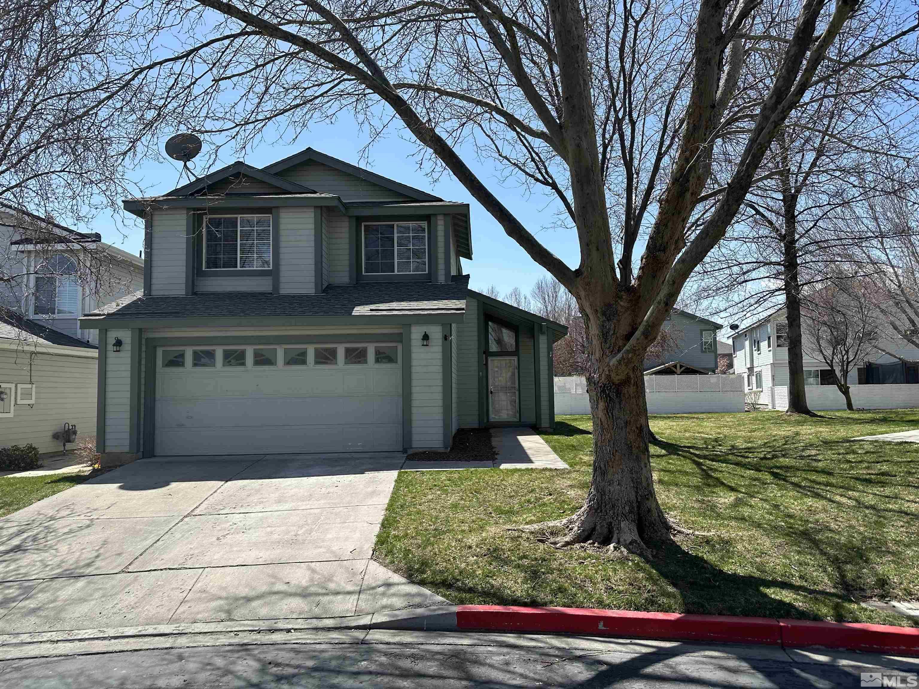 7485 Wheeldale Circle Reno, NV 89511 - Photo 1 of 12 a front view of a house with garden