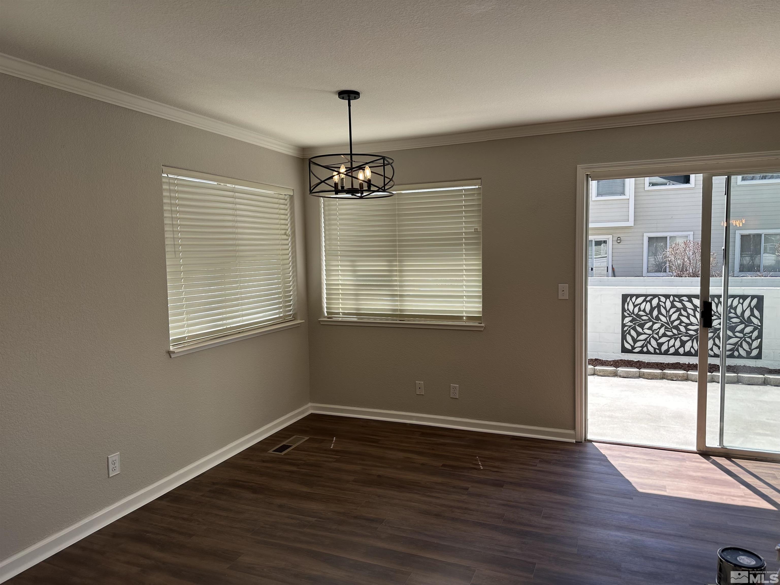 7485 Wheeldale Circle Reno, NV 89511 - Photo 11 of 12 an empty room with wooden floor a ceiling fan and windows