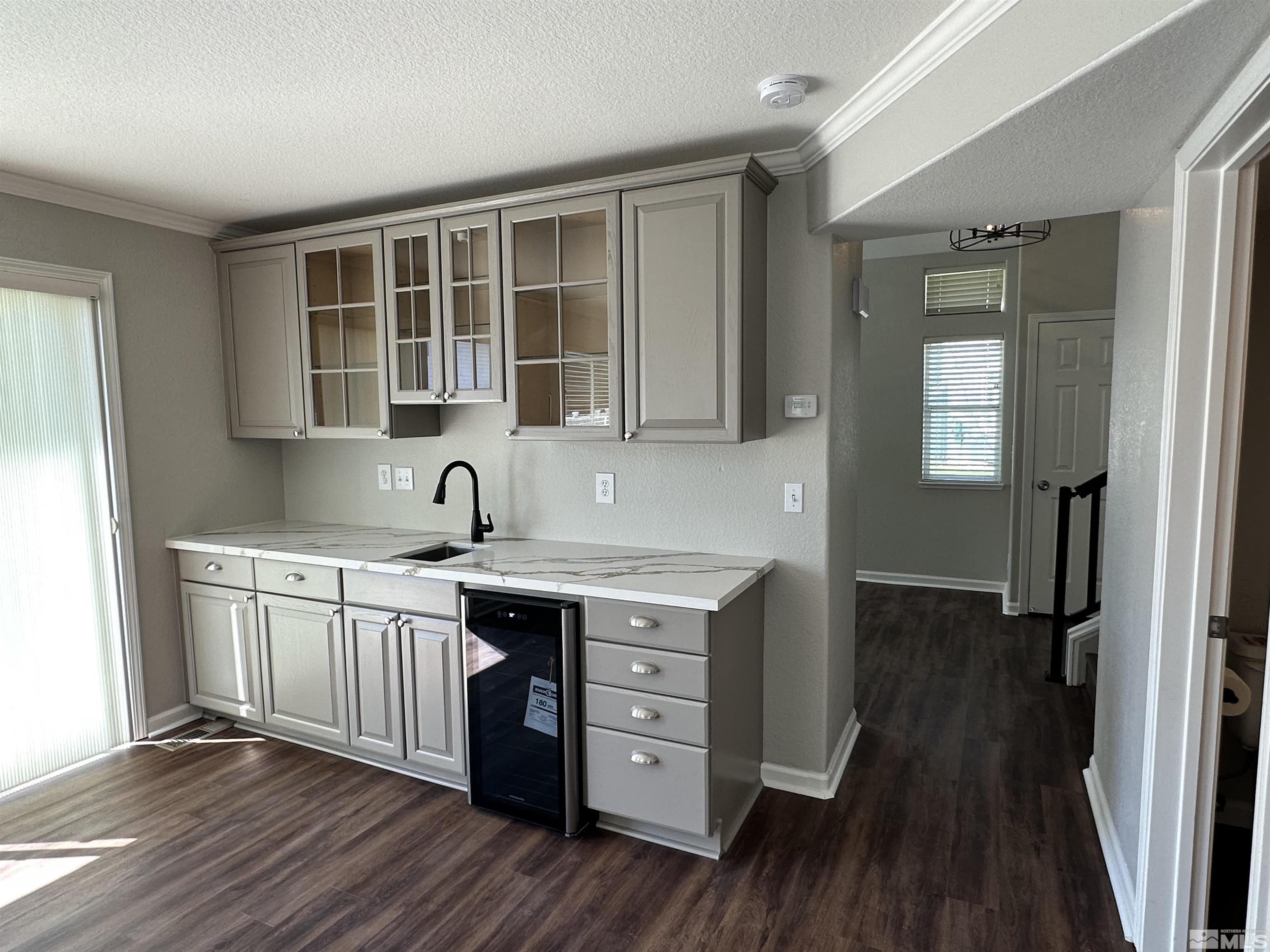 7485 Wheeldale Circle Reno, NV 89511 - Photo 5 of 12 a kitchen with stainless steel appliances granite countertop a sink cabinets and wooden floor