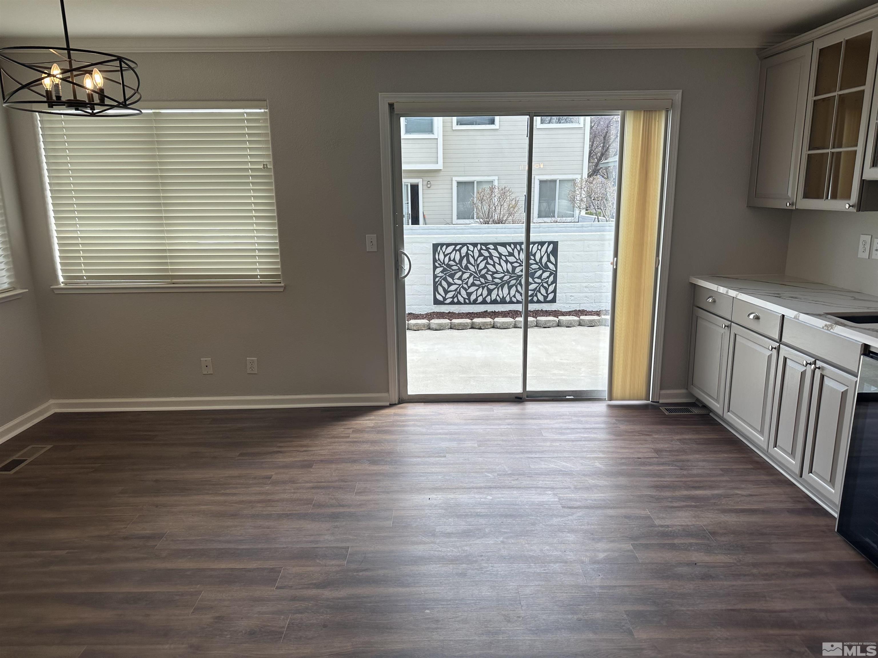 7485 Wheeldale Circle Reno, NV 89511 - Photo 6 of 12 a view of an empty room with a window and wooden floor