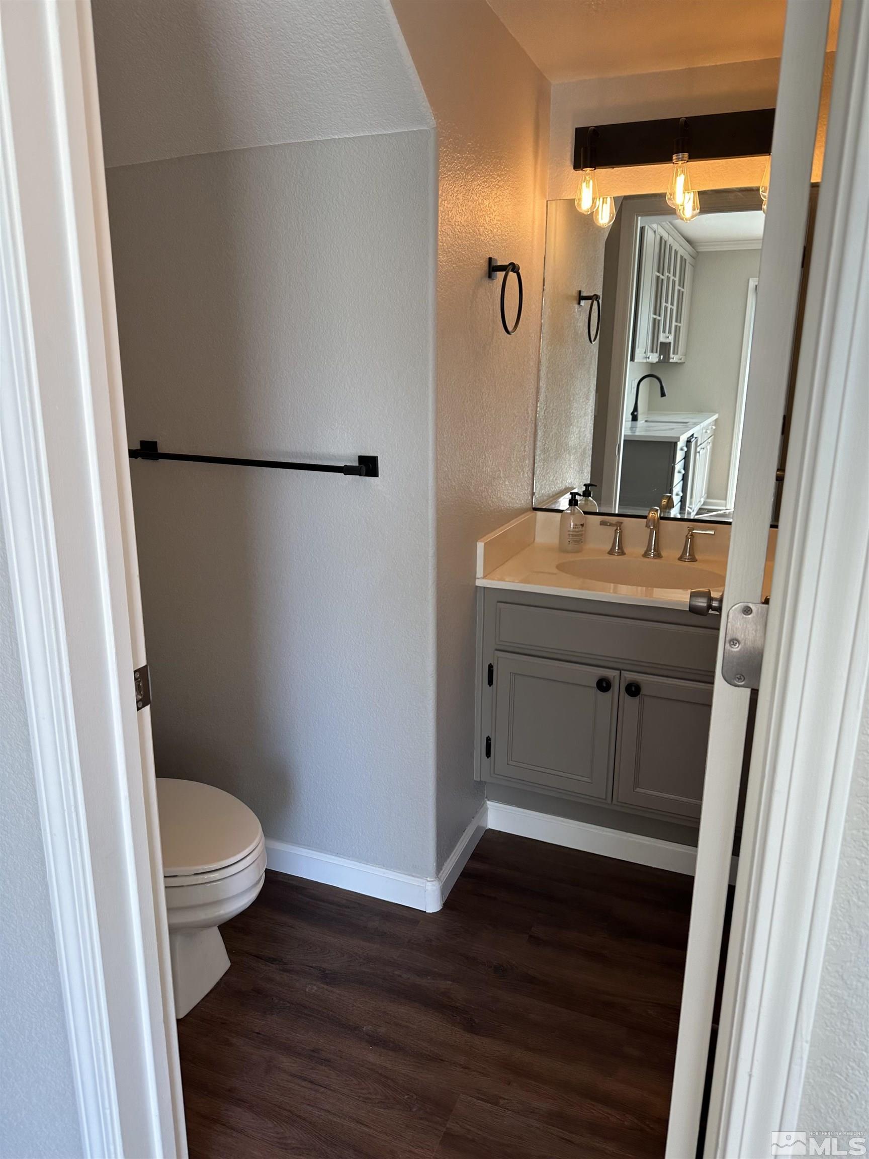 7485 Wheeldale Circle Reno, NV 89511 - Photo 7 of 12 a bathroom with a sink a toilet a mirror and shower