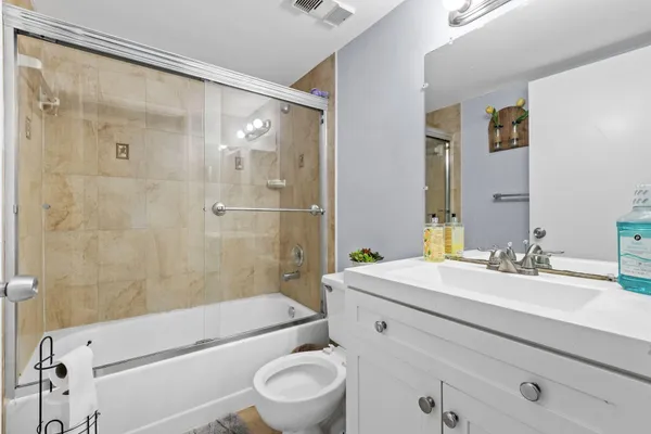 a bathroom with a sink mirror toilet and bathtub