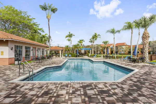 a view of a house with swimming pool and sitting area