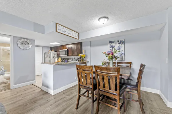a view of a dining room with furniture and wooden floor