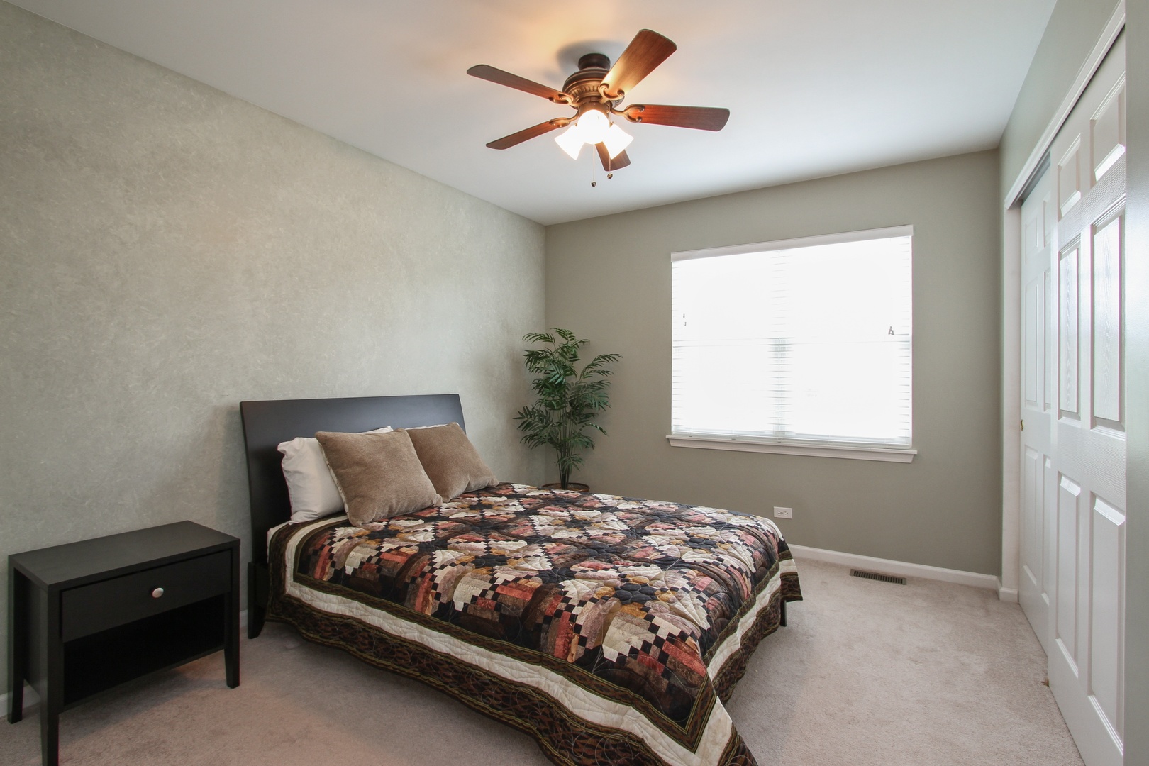 221 Ellis Road Lake In The Hills, IL 60156 - Photo 18 of 28 a bedroom with a bed and a ceiling fan