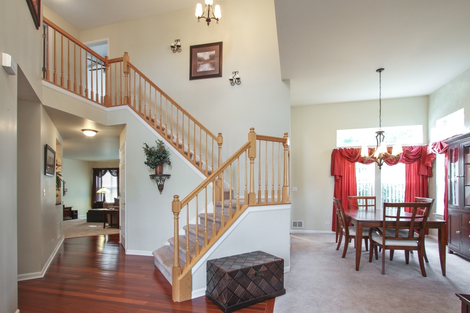 221 Ellis Road Lake In The Hills, IL 60156 - Photo 3 of 28 a view of a livingroom with furniture stairs wooden floor and a chandelier