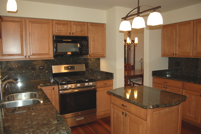 221 Ellis Road Lake In The Hills, IL 60156 - Photo 6 of 28 a kitchen with stainless steel appliances granite countertop a sink a stove and a microwave