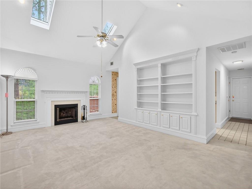 2038 Buford Dam Road Buford, GA 30518 - Photo 16 of 56 a view of an empty room with a fireplace and a window