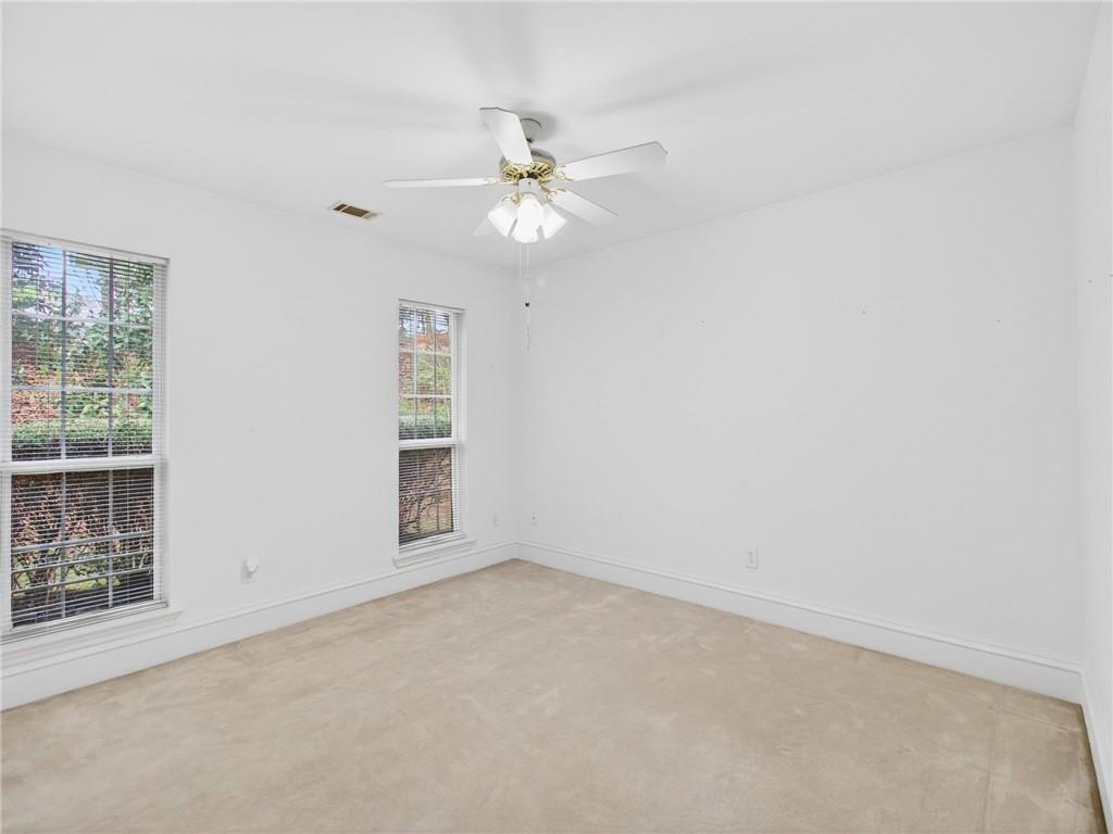 2038 Buford Dam Road Buford, GA 30518 - Photo 18 of 56 an empty room with windows and fan