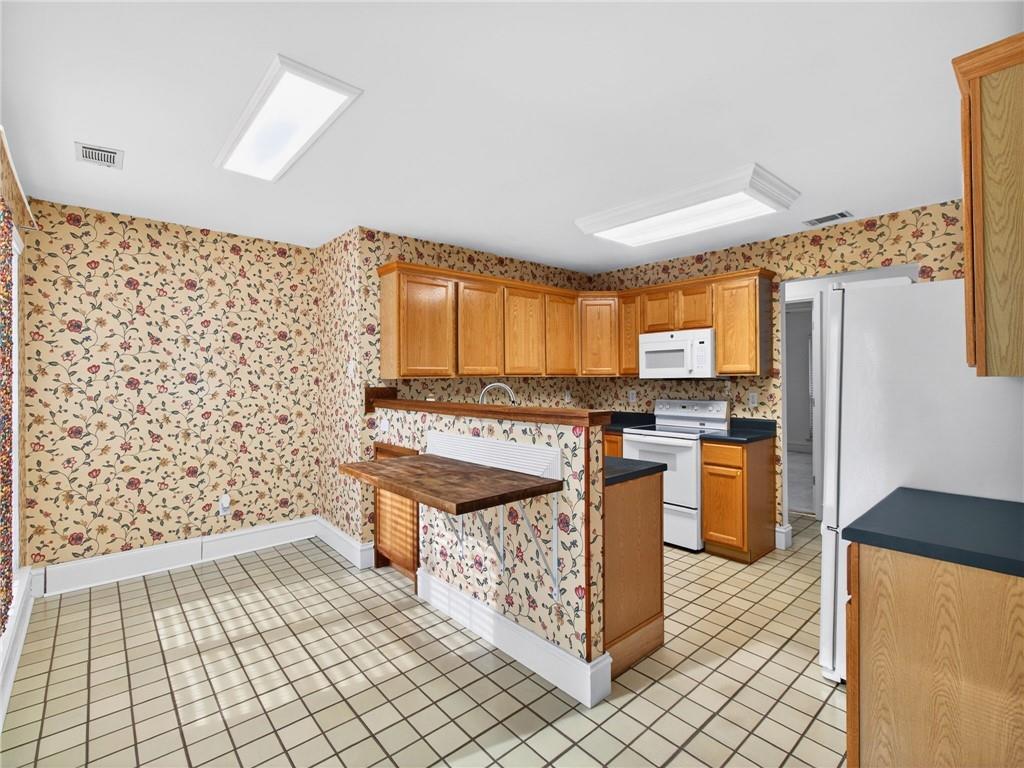 2038 Buford Dam Road Buford, GA 30518 - Photo 24 of 56 a kitchen with stainless steel appliances granite countertop a stove a sink and a refrigerator