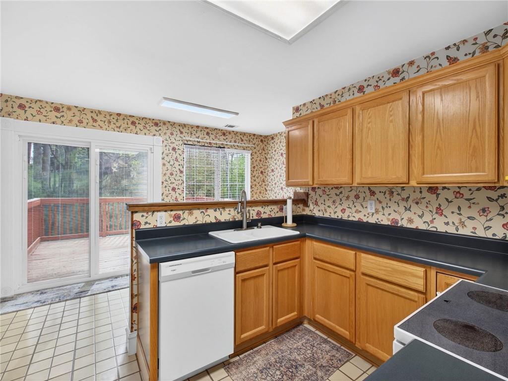 2038 Buford Dam Road Buford, GA 30518 - Photo 26 of 56 a kitchen with a sink stove and cabinets