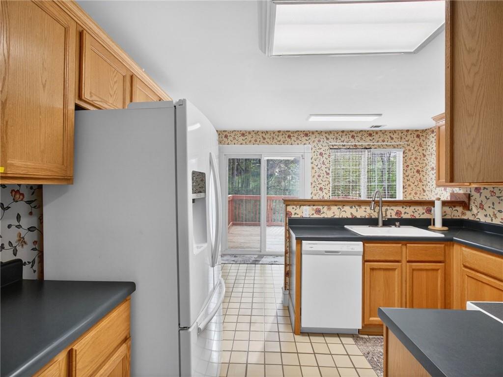 2038 Buford Dam Road Buford, GA 30518 - Photo 27 of 56 a kitchen with stainless steel appliances granite countertop a sink and a stove