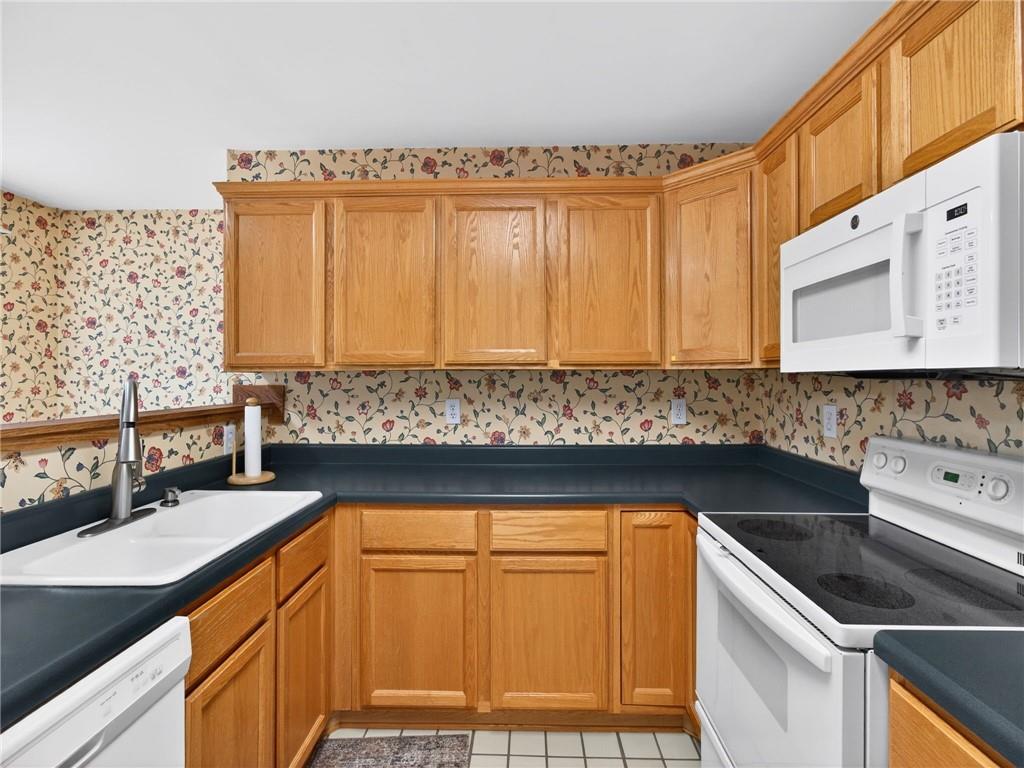 2038 Buford Dam Road Buford, GA 30518 - Photo 28 of 56 a kitchen with stainless steel appliances granite countertop a sink a stove and a microwave