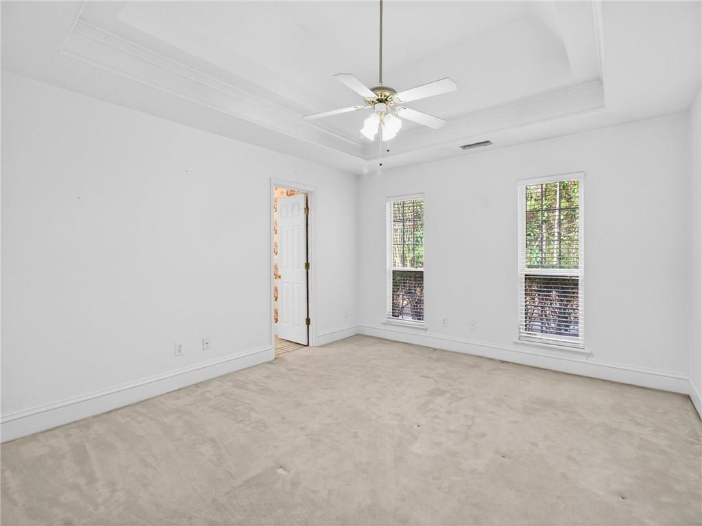 2038 Buford Dam Road Buford, GA 30518 - Photo 29 of 56 an empty room with windows and fan
