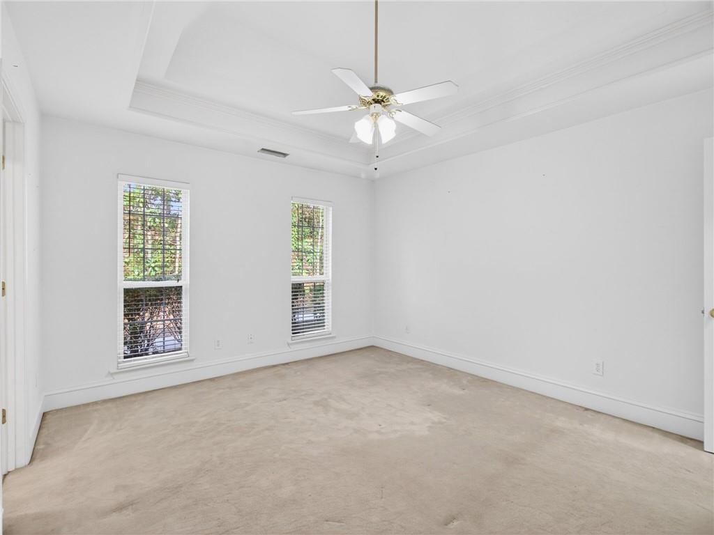 2038 Buford Dam Road Buford, GA 30518 - Photo 30 of 56 an empty room with windows and fan