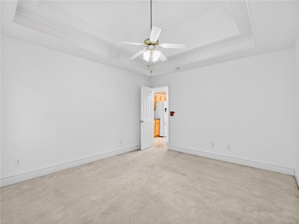 2038 Buford Dam Road Buford, GA 30518 - Photo 31 of 56 an empty room with a ceiling fan and a window