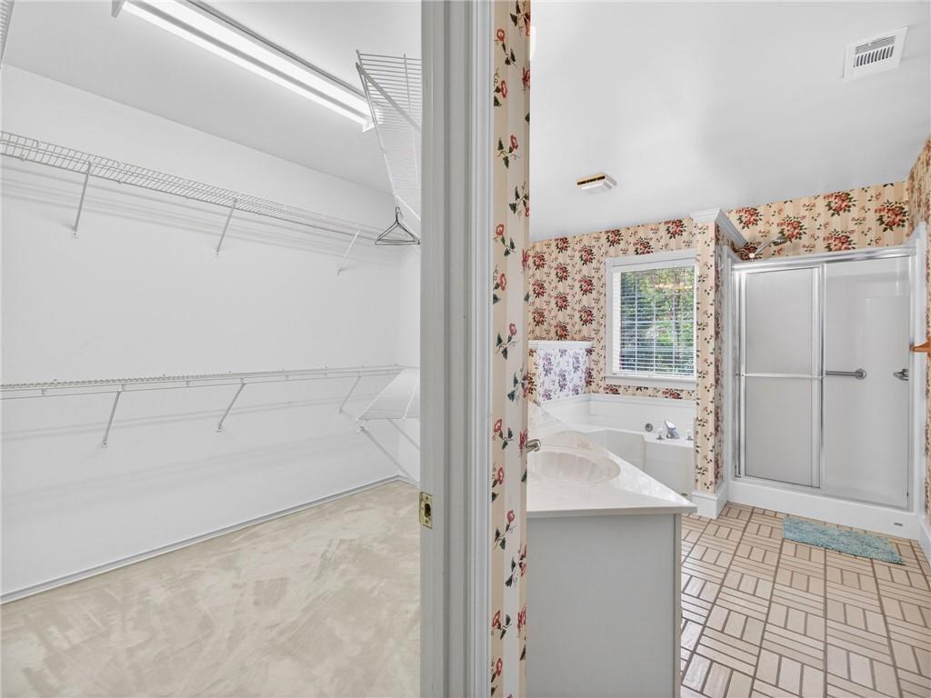 2038 Buford Dam Road Buford, GA 30518 - Photo 32 of 56 a bathroom with a bathtub and shower