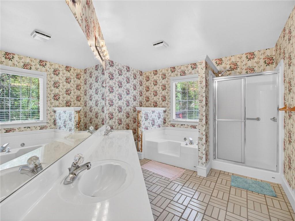 2038 Buford Dam Road Buford, GA 30518 - Photo 34 of 56 a bathroom with a bathtub and a shower