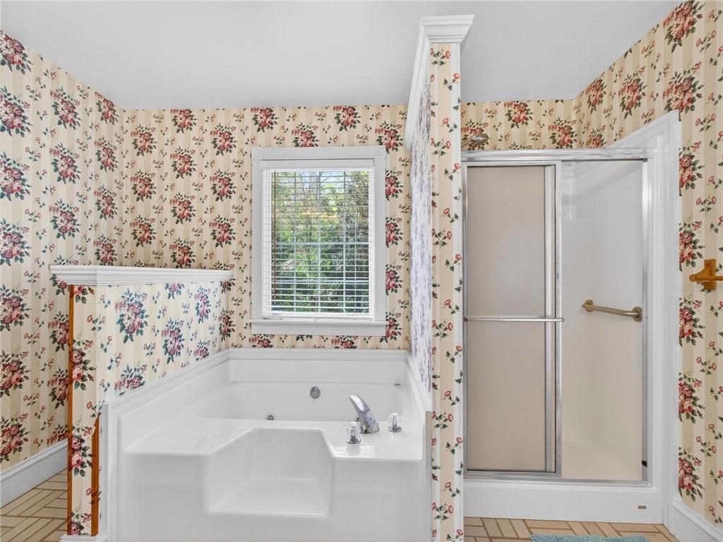 2038 Buford Dam Road Buford, GA 30518 - Photo 36 of 56 a bathroom with a bathtub and shower
